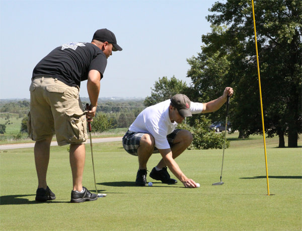 Deputies M. Isley and C. Reese play golf on the course