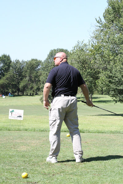 Lt. J. Schmidt on the golf course with golf club