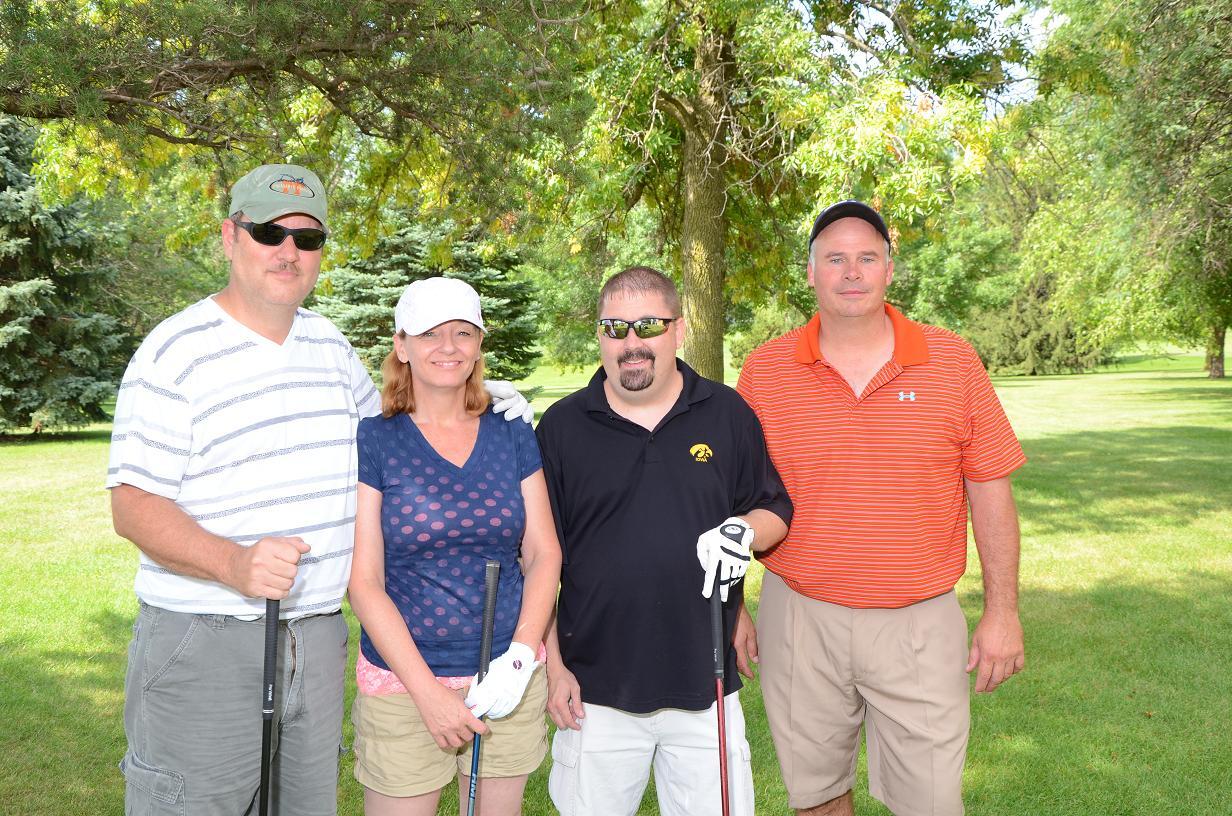 People posing on the golf course for a picture