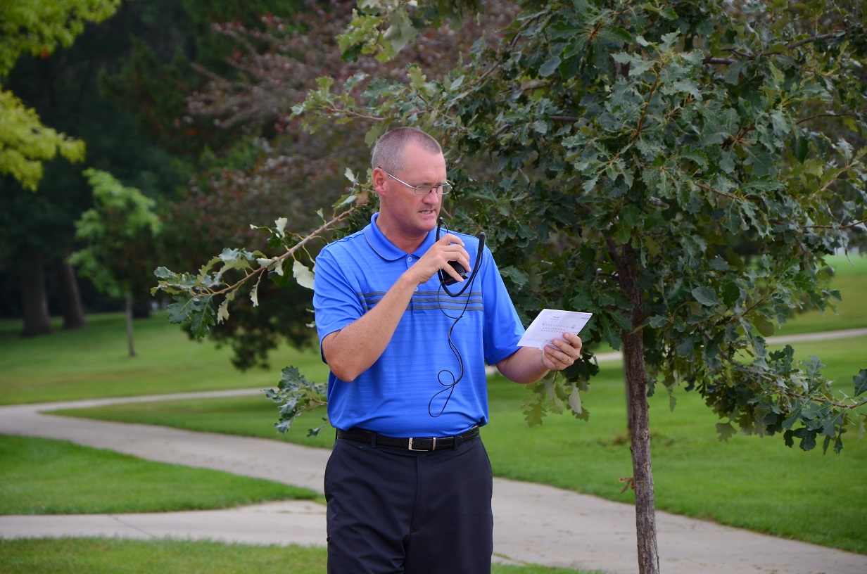 Man looking at piece of paper outdoors