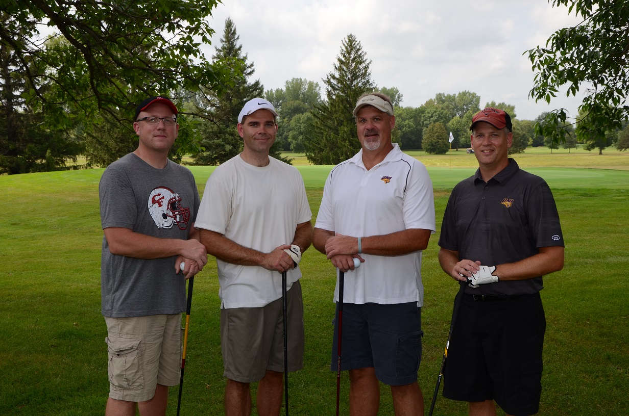 People posing for a photo on the golf course