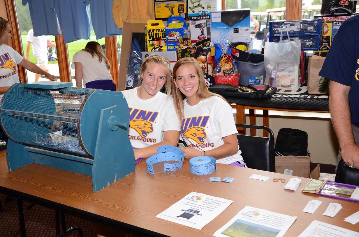 Two UNI students pose in UNI t-shirts.