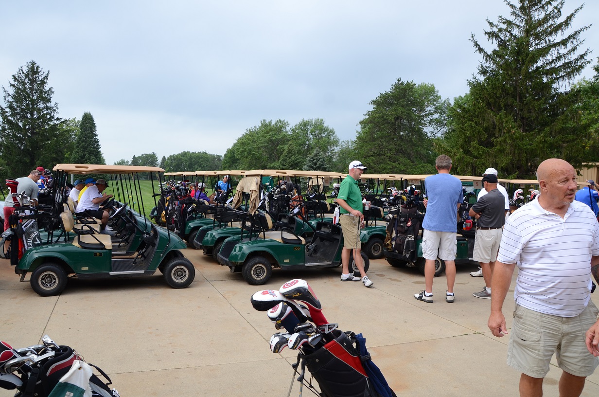 People outside next to the golf carts