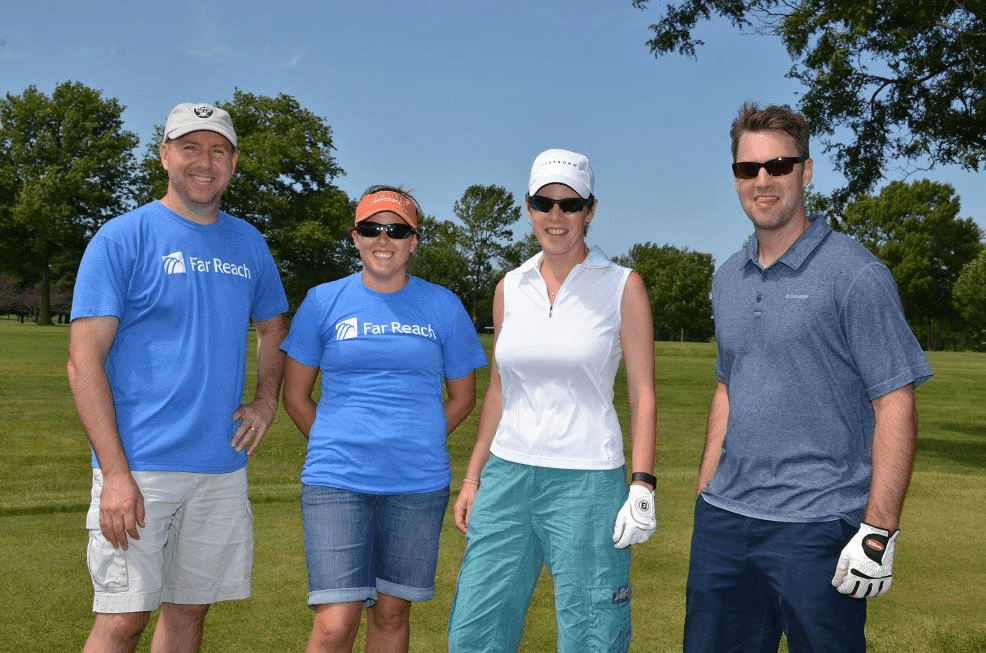 People posing for a photo on the golf course