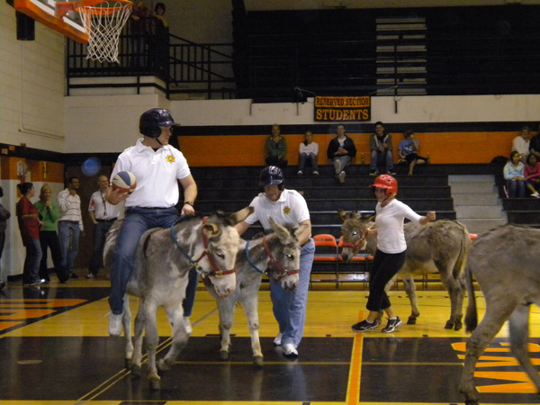 Sheriff Thompson on a donkey holding a basketball
