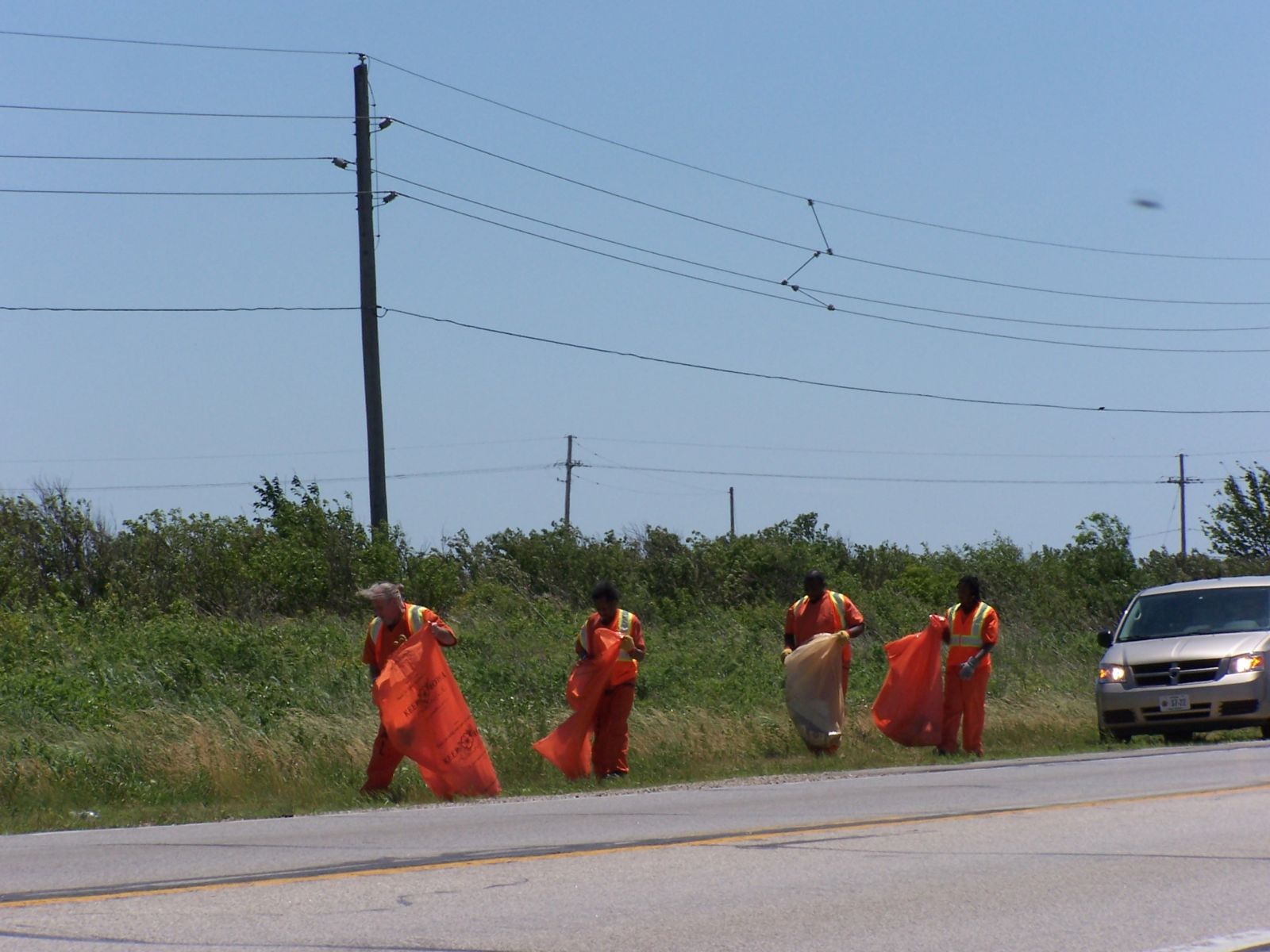 Crew of inmates cleaning up the roadway