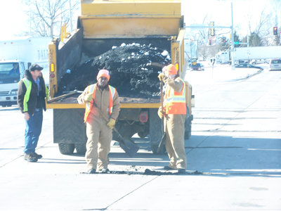 Inmates working together to fill potholes in Waterloo