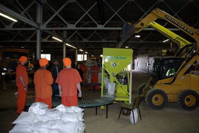 Inmates filling sandbags