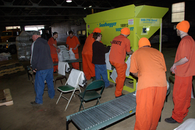 Inmates loading sandbags for flood prevention
