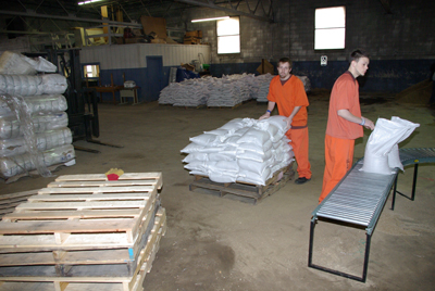 Inmates lifting up sandbags