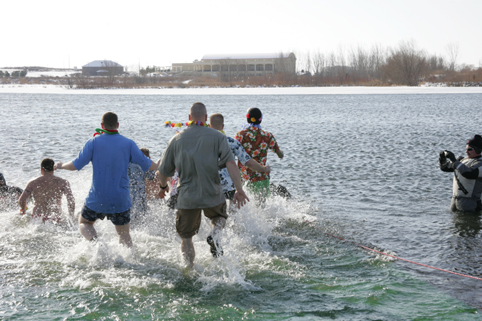 People running into the water during the polar plunge