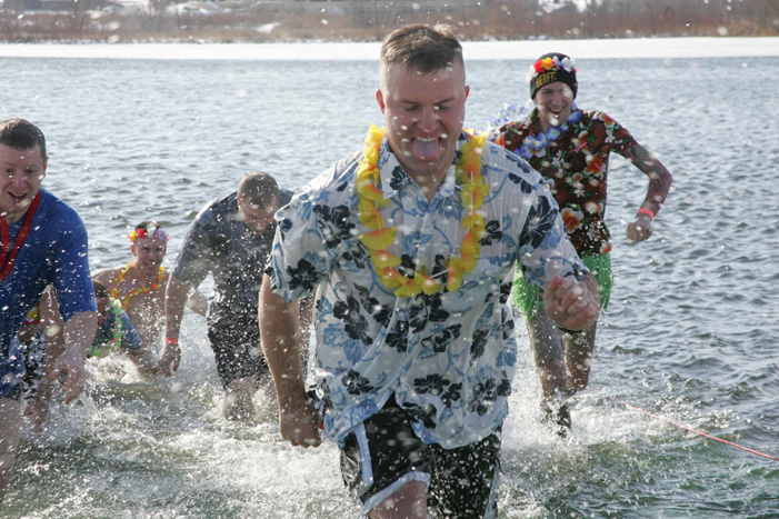 Men running out of the water after a polar plunge