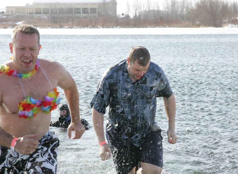 Men exiting the water after participating in polar plunge