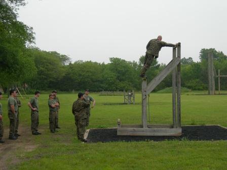 Sheriffs climbing up obstacle