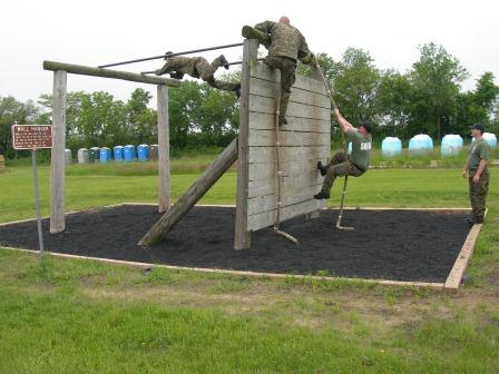 Sheriffs climbing up wall for training