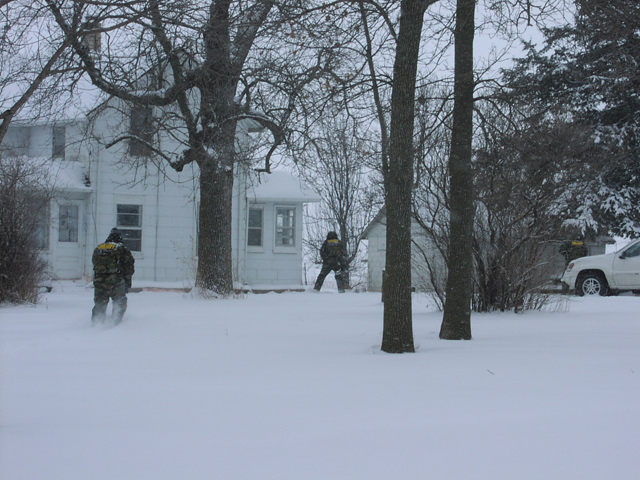 SWAT team approaching house for hostage situation