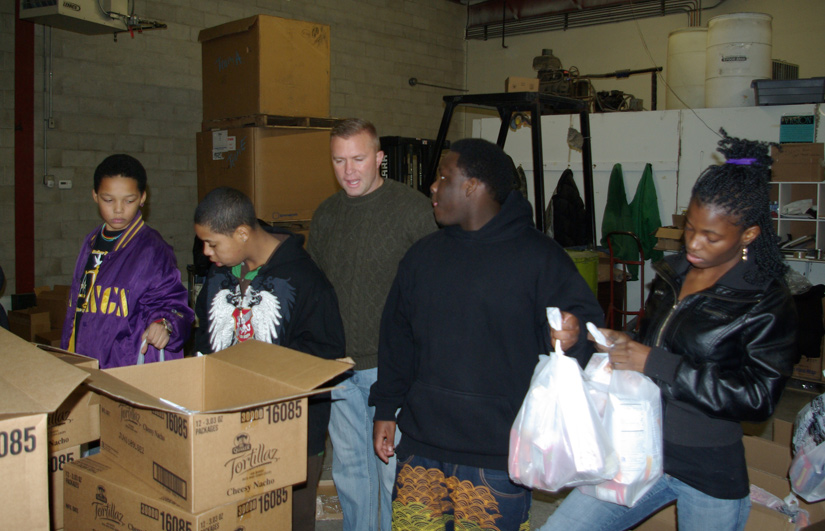 Group of people working together with unpacking food